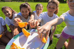 Featured Image for girls team eating oranges