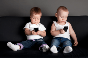 Featured Image for little boy and girl playing with mobile phones