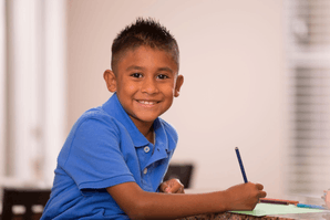 Featured Image for Ethnic school age boy doing homework