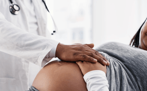 Featured Image for Black pregnant woman with doctor