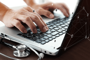 Featured Image for Hand working on computer in medical space