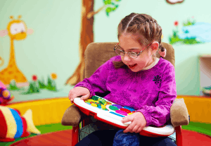 Featured Image for girl in wheelchair playing with toy