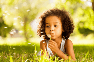 Featured Image for Black girl blowing dandelion fluff