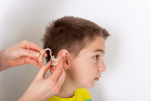 Featured Image for audiologist putting a hearing aid into ear