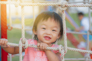 Featured Image for happy toddler playing on playground