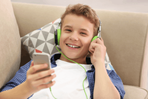 Featured Image for boy listening to music on sofa