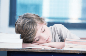 Featured Image for tired child sleeping while studying