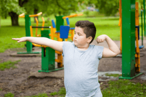 Featured Image for overweight boy showing his muscles