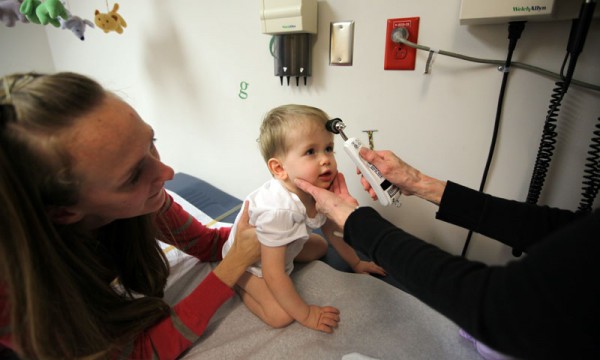 Nurse Betty Dunton takes Jordan's temperature before surgery