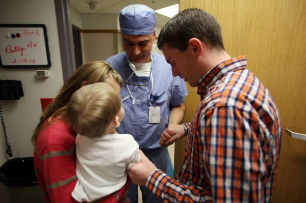 Dr. Milo prays with the Pollocks before surgery