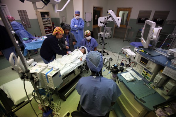 Dr. Farid, Melanie and Sarah Froman administer anesthesia before surgery