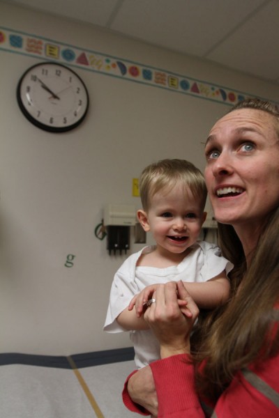 Megan holds Jordan while they wait for the nurse.