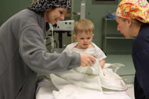 OR nurse Sarah Froman and nurse anesthetist Melanie Stoops get Jordan settled into the OR