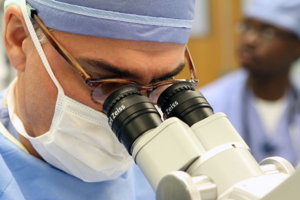 Dr. Milo uses a telescope to insert the tiny ear tube