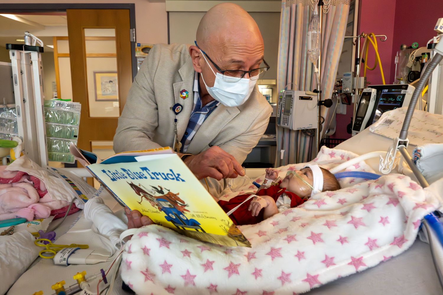 Dr. Robert McGregor, Chief Medical Officer, patient, reading