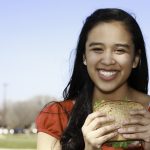 Protein for teen girls: fueling healthy growth and development Smiling Young Woman Eating Healthy Sandwich at a Park