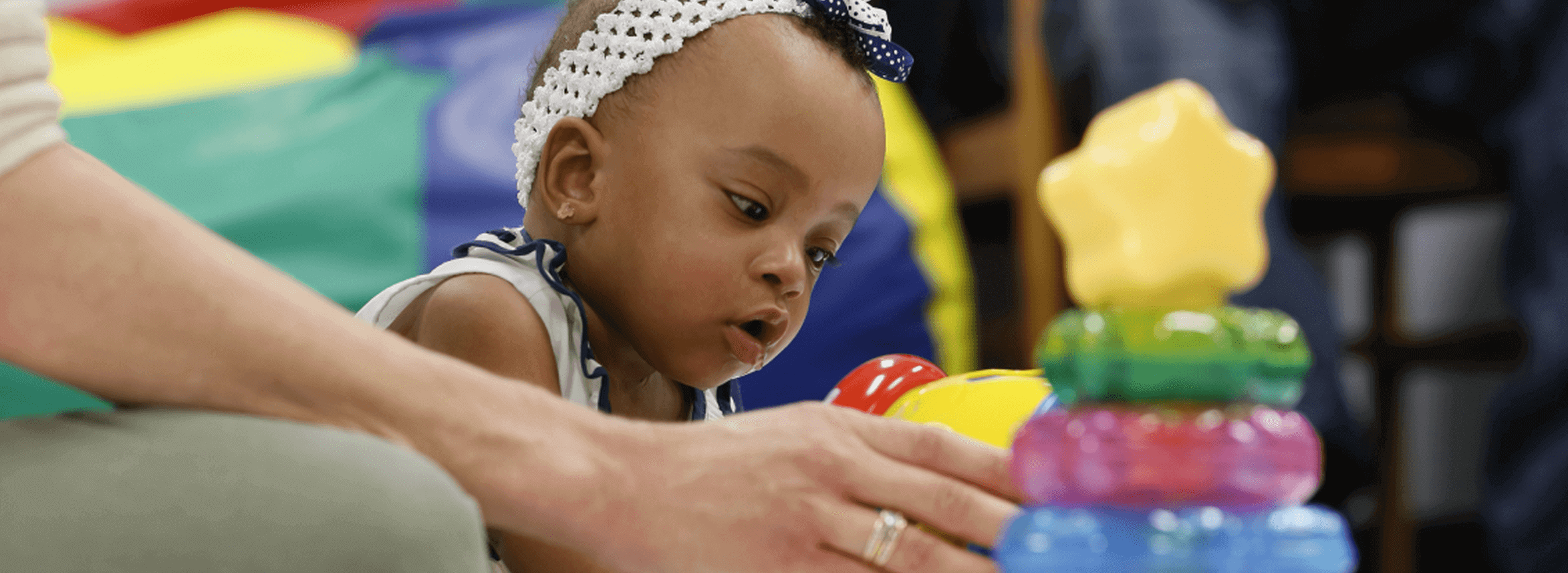 Photo of a baby playing with toys.